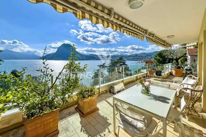 Elegant penthouse apartment for sale in Lugano-Castagnola, featuring breathtaking panoramic views of the lake &amp; a private garden!